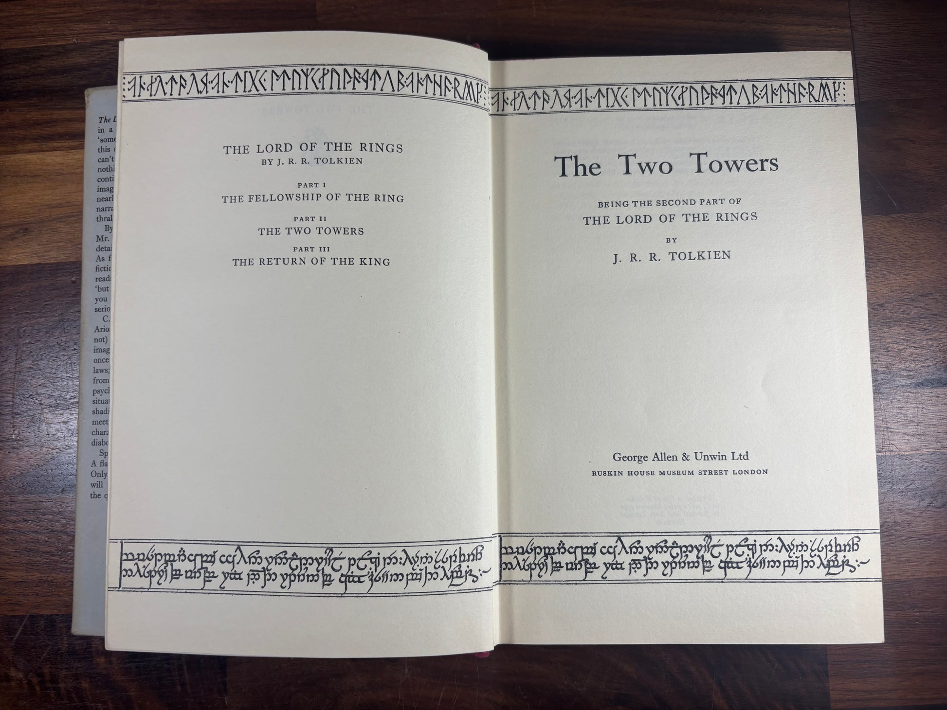 Open book titled 'The Two Towers' by J.R.R. Tolkien on a wooden surface